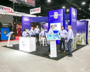 20×20 custom exhibit for System at Modex with interactive media displays
